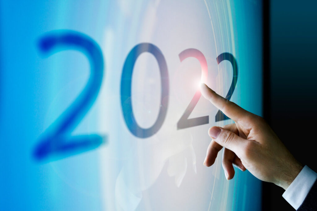 A person pointing to a screen, with 2022 written